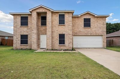 View of front of property with a garage and a front yard | Image 1