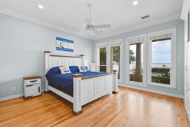 Enjoy stunning lake views from the primary bedroom overlooking the porch. | Image 22