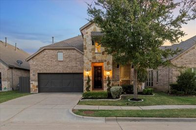 View of front of property featuring a yard and a garage | Image 1