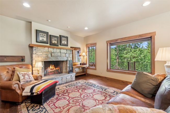 Living room featuring a fireplace, finished floors, and recessed lighting | Image 13