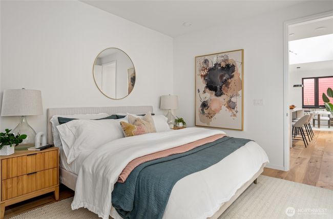 The main floor primary suite offers ultimate convenience and luxury, featuring an ensuite bathroom and an entire wall of built-in Abodian closets for exceptional storage and organization. | Image 13