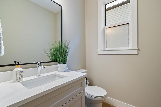 Half bathroom featuring vanity and wood finished floors | Image 16
