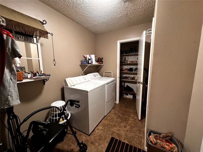 Washroom with separate washer and dryer and a textured ceiling | Image 18