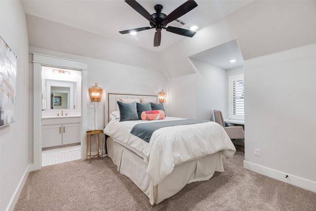 Bedroom with light colored carpet, a sink, connected bathroom, and baseboards | Image 30