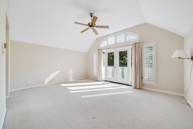 Interior space featuring baseboards, a ceiling fan, french doors, and lofted ceiling | Image 19