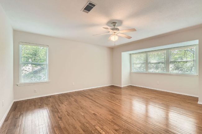 Empty room featuring baseboards, ceiling fan, hardwood / wood-style flooring, and visible vents | Image 17