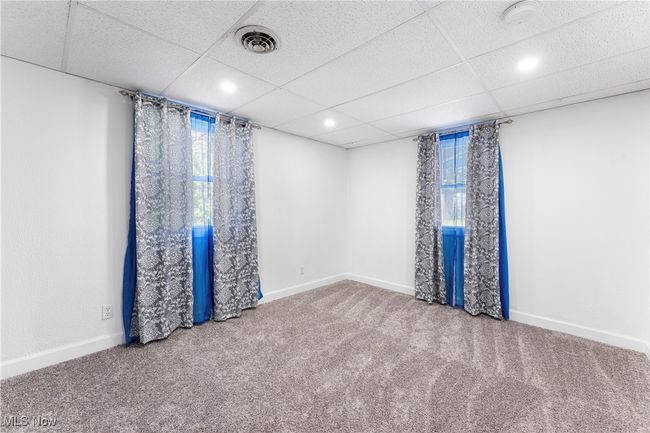 Carpeted empty room featuring baseboards, visible vents, and recessed lighting | Image 19