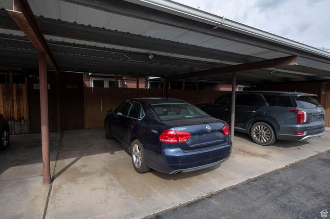 Covered parking lot featuring fence | Image 20