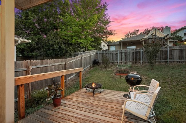 Relax on the covered back patio or deck offering the perfect spot to watch the sunset in your private, fenced in yard. | Image 33
