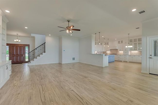 The open-concept floor plan offers a seamless flow, perfect for entertaining while creating a spacious and airy atmosphere throughout the home. | Image 12