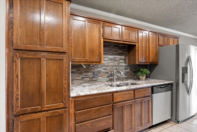 Beautiful granite countertops and backsplash. | Image 15