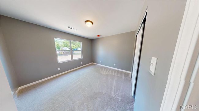 Unfurnished bedroom with baseboards, light carpet, and a closet | Image 18