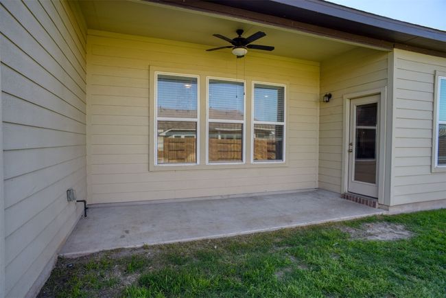 The covered back porch even has a ceiling fan to keep you cool and comfy on those sweet summer evenings. | Image 31