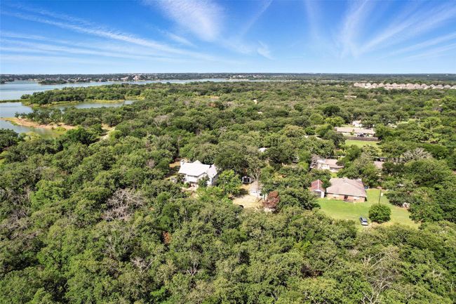 Bird's eye view of a heavily wooded area and a large body of water | Image 17