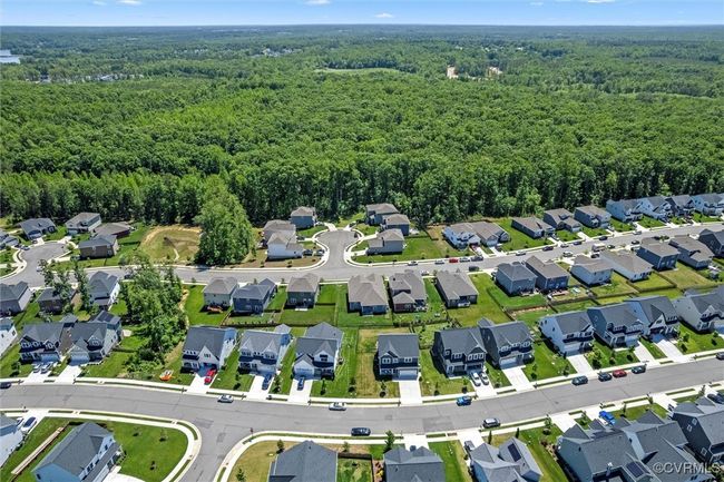 Aerial view of property's location featuring a forest and nearby suburban area | Image 49