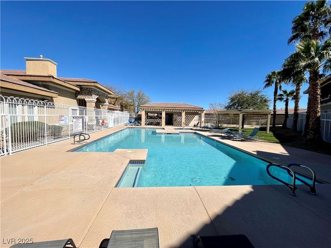 Community pool with a pergola, a patio area, and fence | Image 49