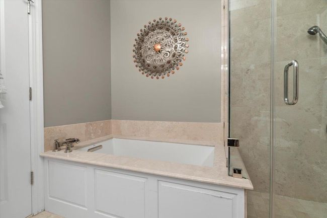 Full bathroom featuring a shower stall and a bath | Image 16