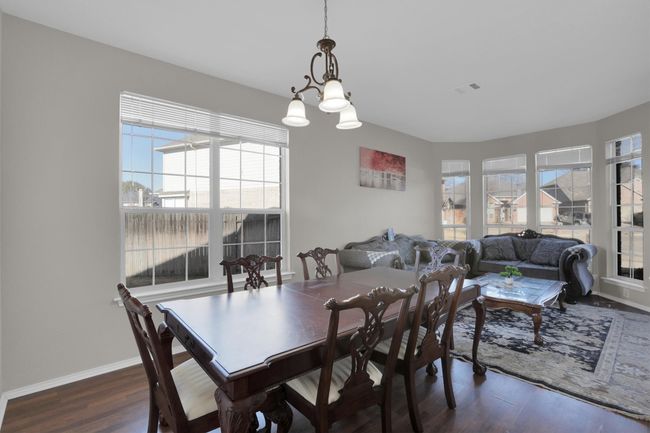 Dining area with baseboards, visible vents, and dark wood-type flooring | Image 21