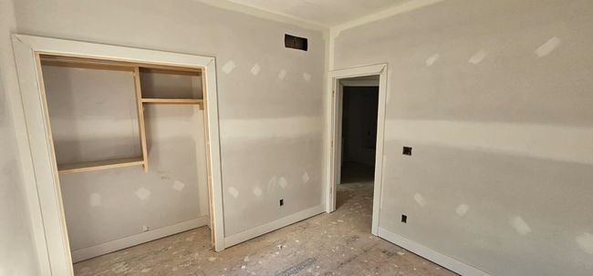 Unfurnished bedroom featuring a closet | Image 6