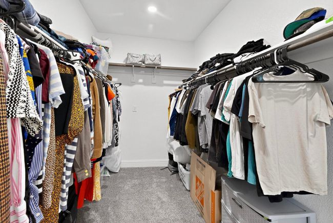 Spacious closet featuring light carpet | Image 20