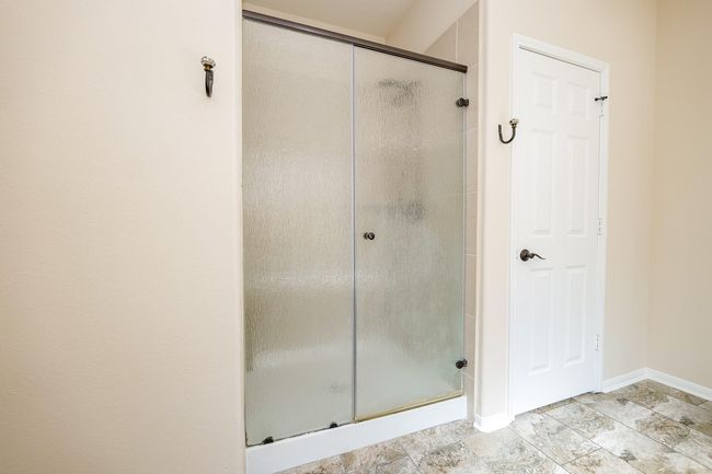 Your primary walk-in shower makes for a comfortable, practical use of space! | Image 27