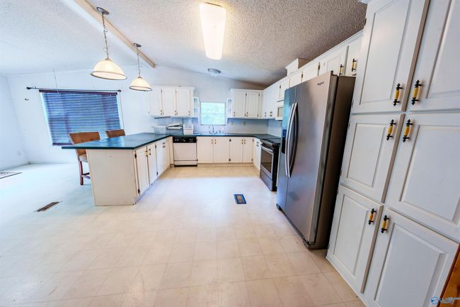 Eat-in kitchen with vaulted ceiling and patio doors to deck | Image 14