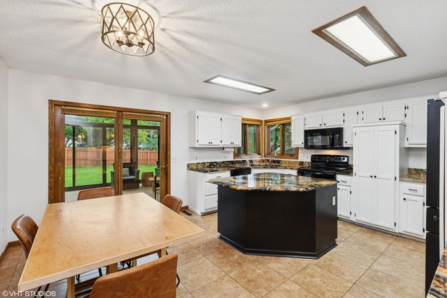 Informal dining area right off the kitchen for easy meals and great conversation | Image 15