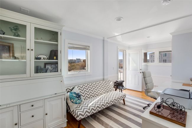 Office space with light wood-type flooring, ornamental molding, and wainscoting | Image 15