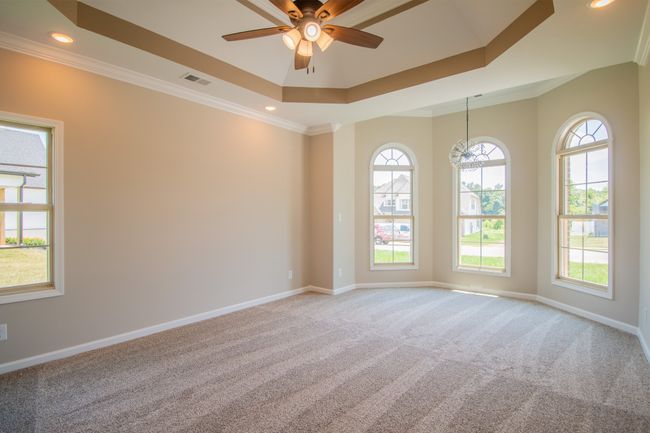 Primary Bedroom Features a Sitting Area, Double Tray Ceiling, Crown Molding and Recessed Lighting! | Image 9