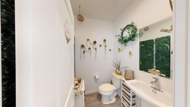 A few steps from the front door, you have the powder room. | Image 4