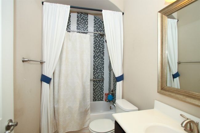 Full bathroom featuring toilet, vanity, and shower / bath combo | Image 22