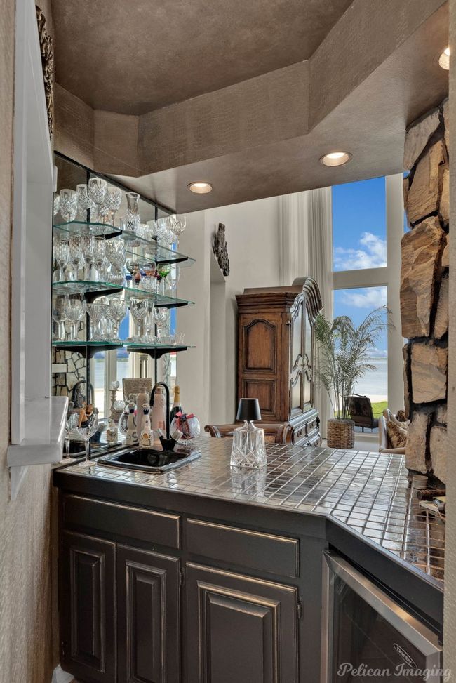 Bar featuring a sink, beverage cooler, and indoor wet bar | Image 8