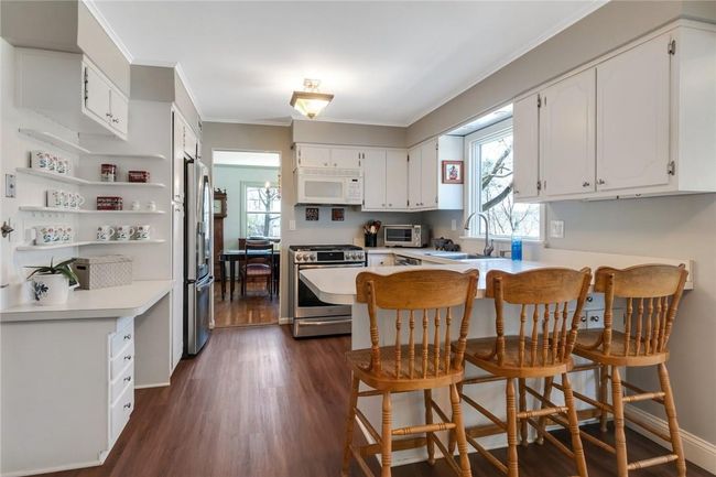 Kitchen with stainless steel appliances, gas range, window with seasonal Hudson River view. | Image 7