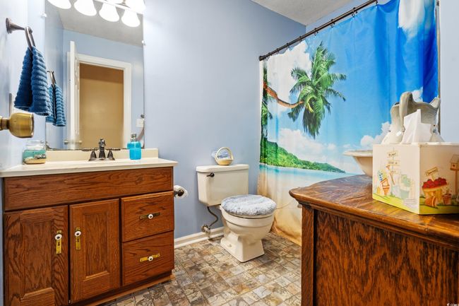 Full bath featuring vanity, toilet, and baseboards | Image 17
