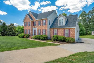 Colonial inspired home with a front yard | Image 2