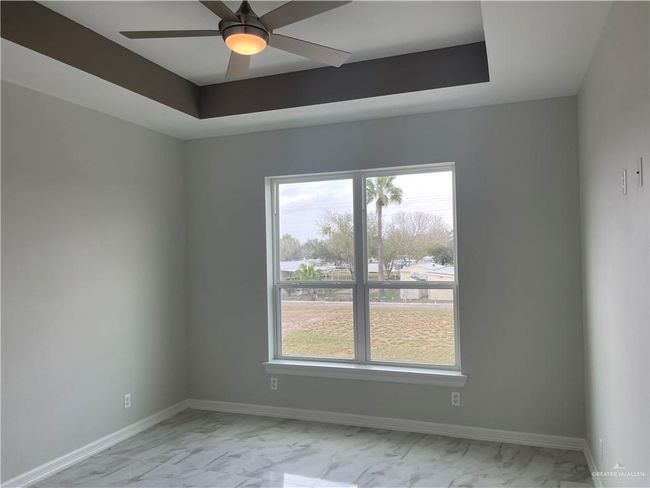 Spare room with light marble finish floors, baseboards, and ceiling fan | Image 13