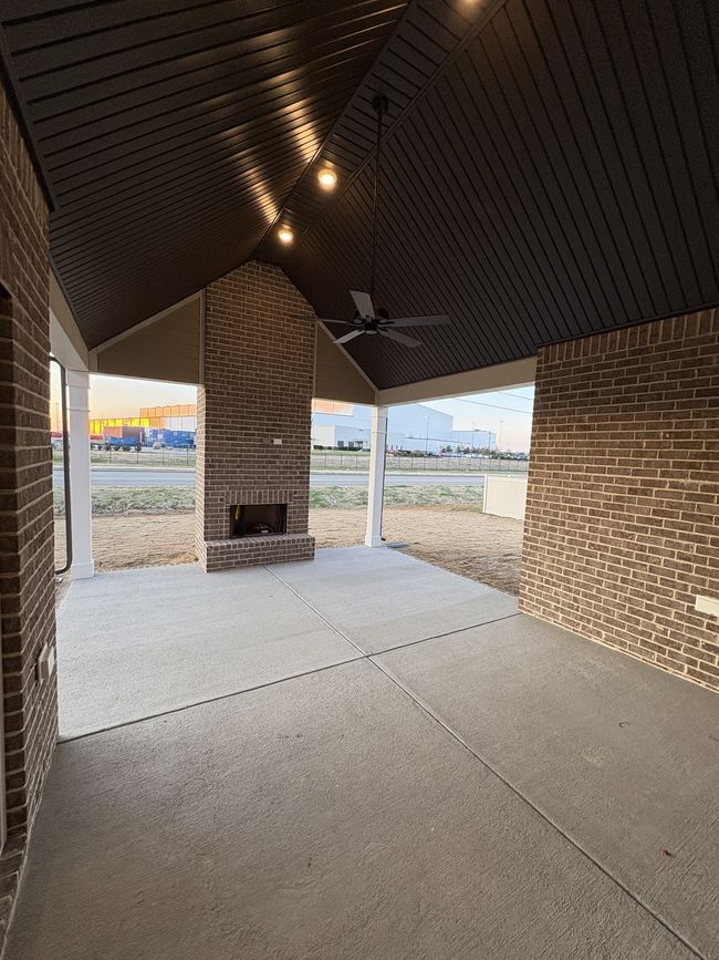STOCK PHOTO. SELECTIONS WILL VARY IN ACTUAL HOUSE. Jumbo covered patio with cathedral ceiling and exterior wood-burning fireplace. | Image 13