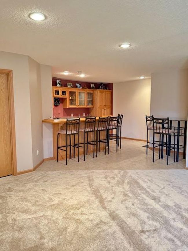 Huge family room with built in bar. | Image 17