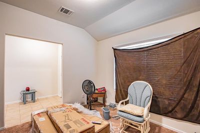 Living area with lofted ceiling and light tile patterned floors | Image 3