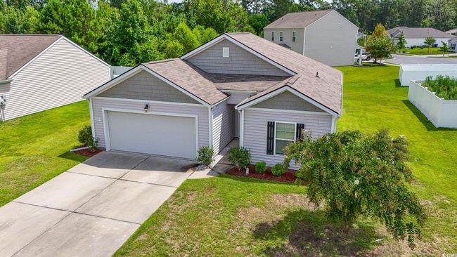 View of front of home with an attached garage, driveway, a front yard, and a shingled roof | Image 5