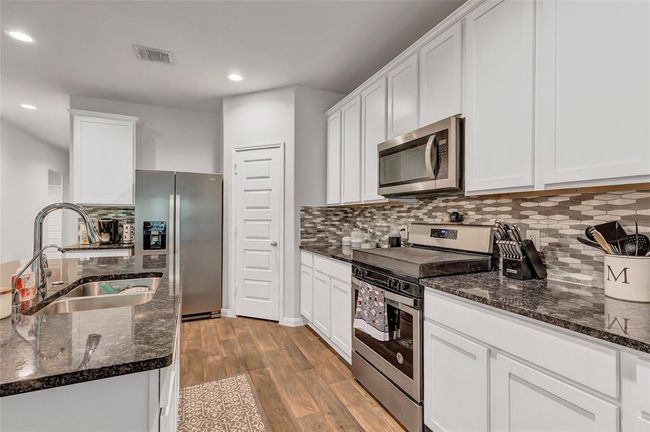 Kitchen with island sink and an abundance of storage space. Large pantry | Image 19