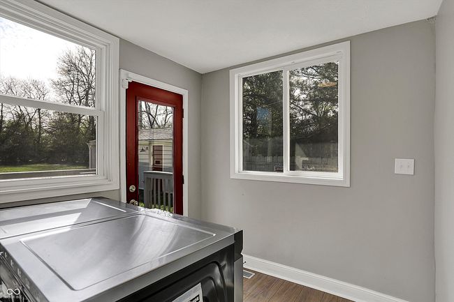 interior space with washing machine and dryer, baseboards, a wealth of natural light, and dark wood-type flooring | Image 22