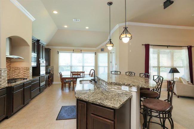 Cabinets with a medium brown stain is a traditional presentation. Garbage disposal 2025. | Image 20