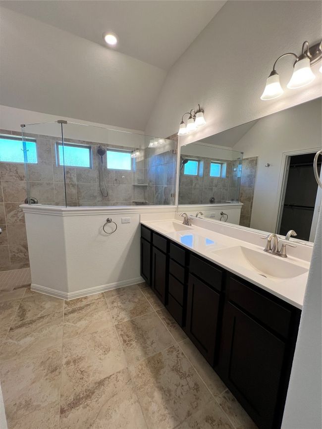 Bathroom with vaulted ceiling, double vanity, and walk in shower | Image 31