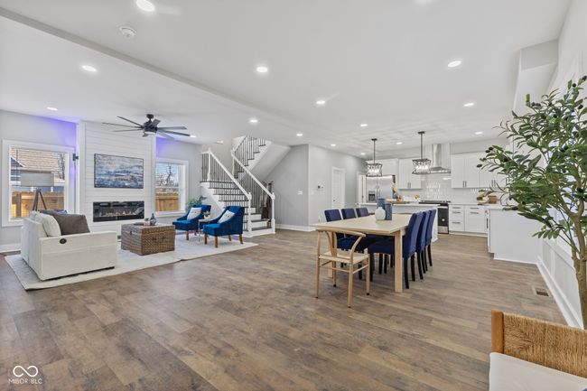 dining area featuring recessed lighting, a fireplace, stairs, and ceiling fan | Image 7