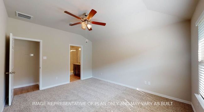 Unfurnished bedroom with carpet, vaulted ceiling, baseboards, and connected bathroom | Image 14