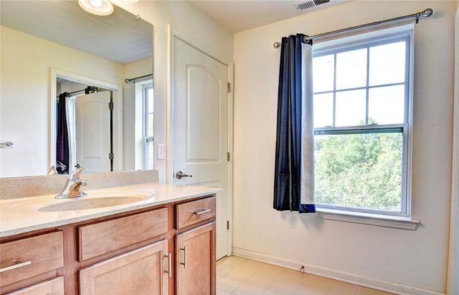 Bathroom with healthy amount of natural light, vanity, and tile floors | Image 24