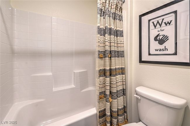 Photo is representational only; actual home finishes may vary. Bathroom with toilet and shower / bath combo | Image 37