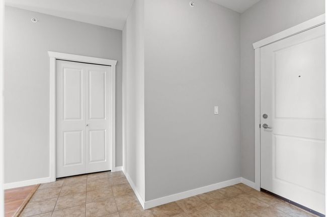 Foyer featuring light tile and entrance feels more like a home. | Image 33