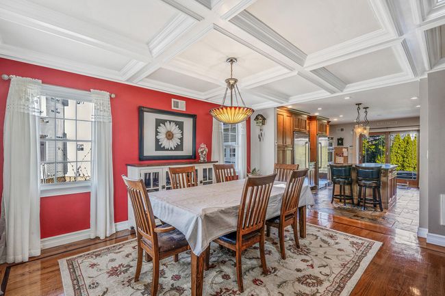 Dining space with coffered ceiling, hardwood / wood-style floors, baseboards, beam ceiling, and visible vents | Image 4
